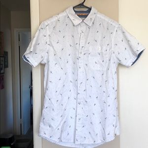 White collared shirt w/ paper airplanes